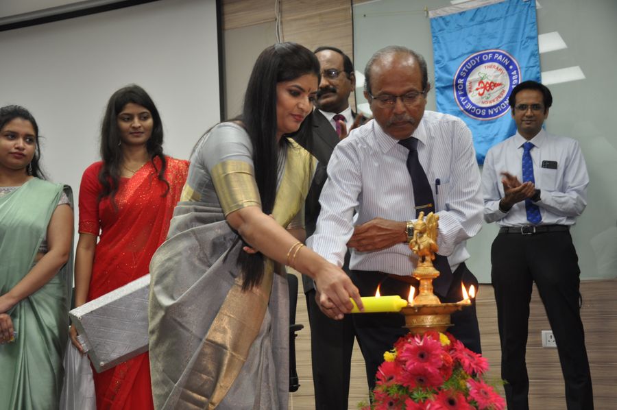 Dr. Kalpana K lighting the ceremonial lamp at an Indian Society for Study of Pain academic event