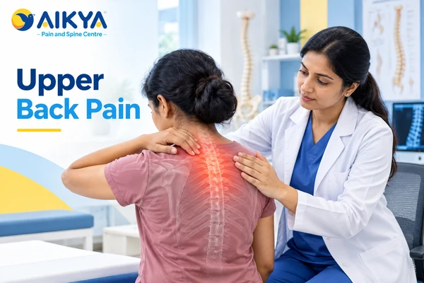 Doctor examining a patient's upper back with the painful area highlighted during upper back pain treatment in Bangalore
